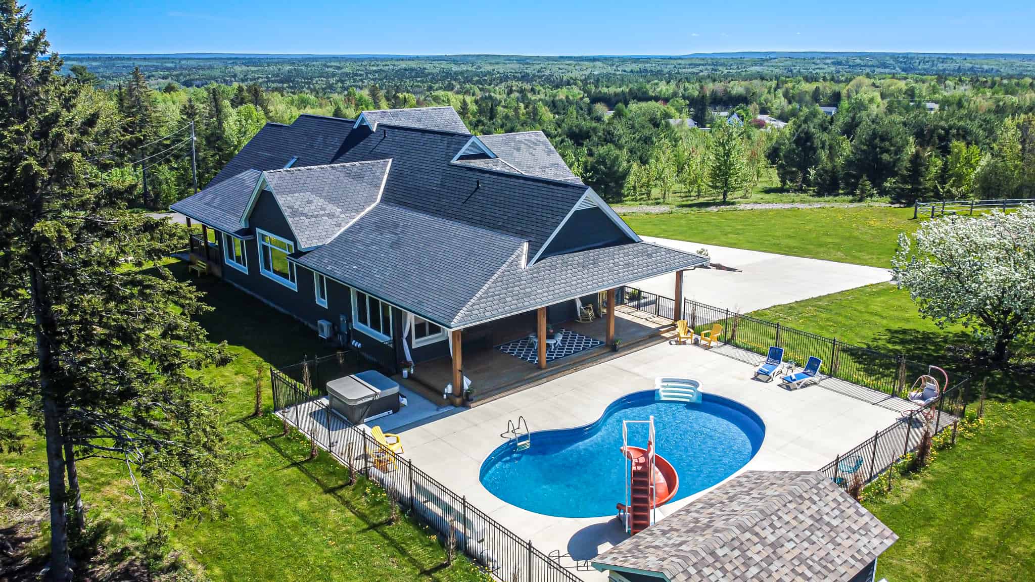 Exterior Aerial image of 1 Sunset Boulevard in Fredericton, New Brunswick showing the fenced-in pool area