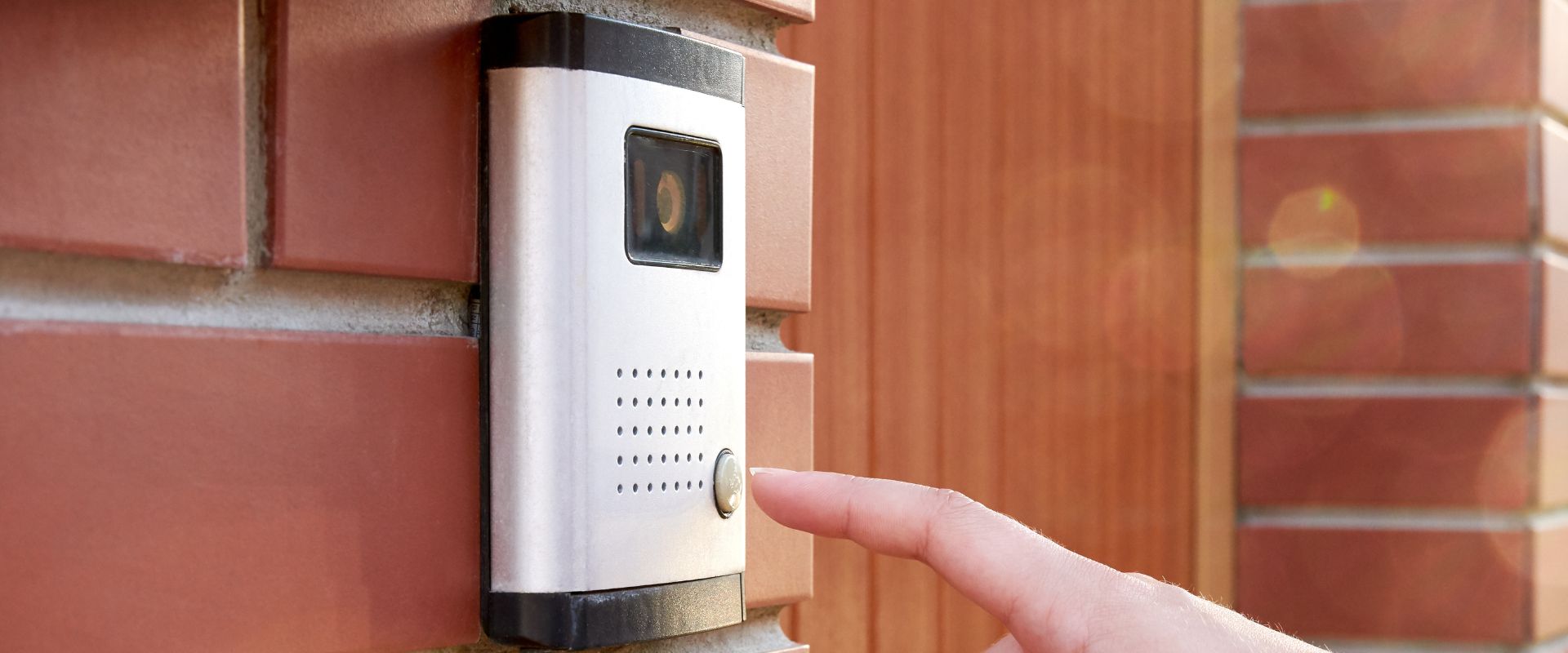 woman pressing a doorbell camera button